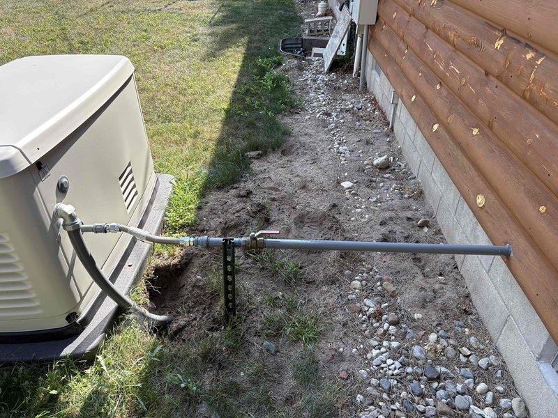Corrected inspector-identified deficiencies on exterior plumbing system by applying corrosion-resistant coating to exposed metallic piping and fittings, and installed proper support brackets to secure unsupported pipe sections in accordance with code requirements.