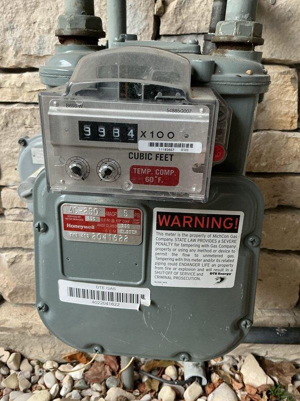 Conducted site assessment for standby generator installation. Documented existing electrical service with Consumers Energy 320-amp, 240-volt, 3-wire meter equipped with 15-minute interval monitoring capability. Evaluated natural gas service infrastructure, confirming availability of fuel source via existing Honeywell meter with adequate capacity rating of 40-250 CFH. Photographed utility connections, service entry configuration, and meter locations to develop comprehensive generator sizing and installation proposal.