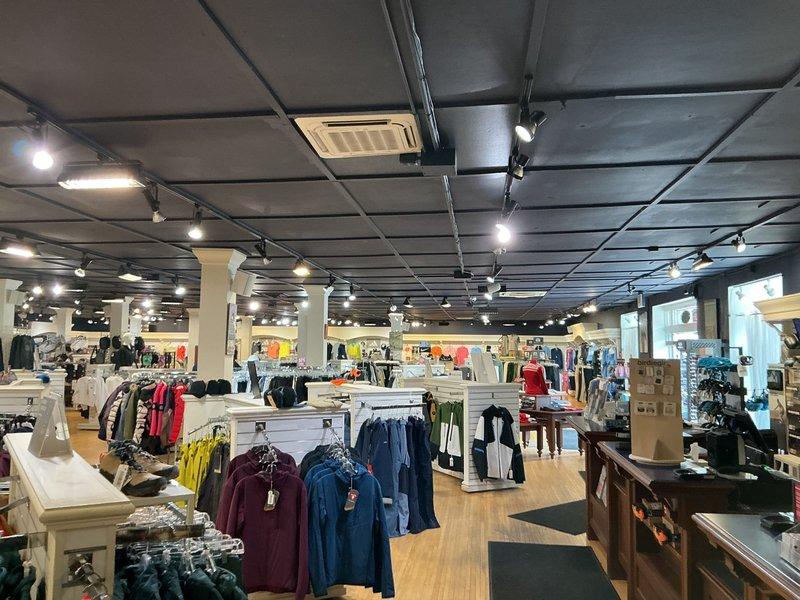 Conducted comprehensive HVAC system assessment at retail sports location experiencing multi-zone mini-split system failure. Evaluated existing configuration consisting of seven mini-split head units (six ceiling-mounted cassettes on main retail floor and one high-wall unit in office) served by four outdoor condenser units mounted on roof. Only one ceiling cassette providing minimal cooling capacity. Inspected roof-mounted condensing units, electrical connections, refrigerant lines, and indoor air handlers to determine extent of system deterioration. Documented current equipment layout and photographed installation for replacement planning. Provided consultation on replacement options including continuing with mini-split configuration versus converting to traditional forced air ducted system, considering building layout, load requirements, and operational efficiency for commercial retail environment.