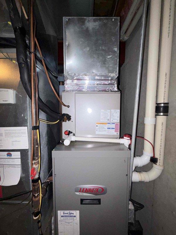 Completed annual heating maintenance visit on residential property with four furnace units and four AC systems. Performed comprehensive inspection of all heating equipment including Lennox furnace installations located in basement mechanical areas. Evaluated refrigerant line connections, copper piping integrity, and insulation condition throughout the system. Noted significant condensation accumulation on black foam pipe insulation and service valve assemblies, indicating potential humidity concerns in mechanical space. Inspected all electrical connections, safety switches, and control wiring on furnace and air handler units. Verified proper operation of PVC condensate drain lines and venting systems. Documented equipment conditions with photographs for service records. All four furnaces assessed for seasonal readiness with attention to copper line connections and brass service valves where moisture was present on surfaces.