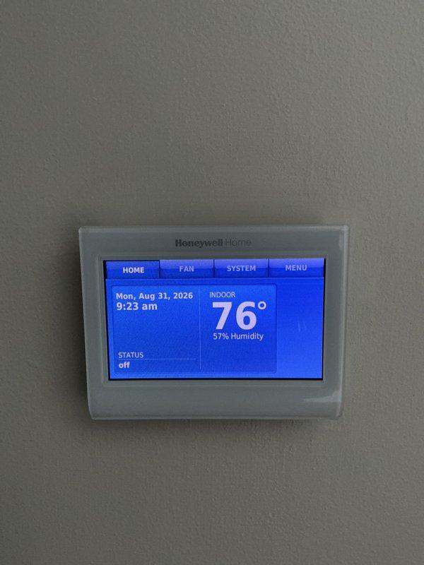 Conducted on-site assessment for AC system replacement estimate. Documented existing HVAC equipment including Bryant furnace and current thermostat configuration. System evaluation revealed need for crane access to complete installation due to property constraints. Captured detailed photos of indoor equipment, thermostat displaying 76° with 57% humidity, and overall system layout for accurate proposal preparation.