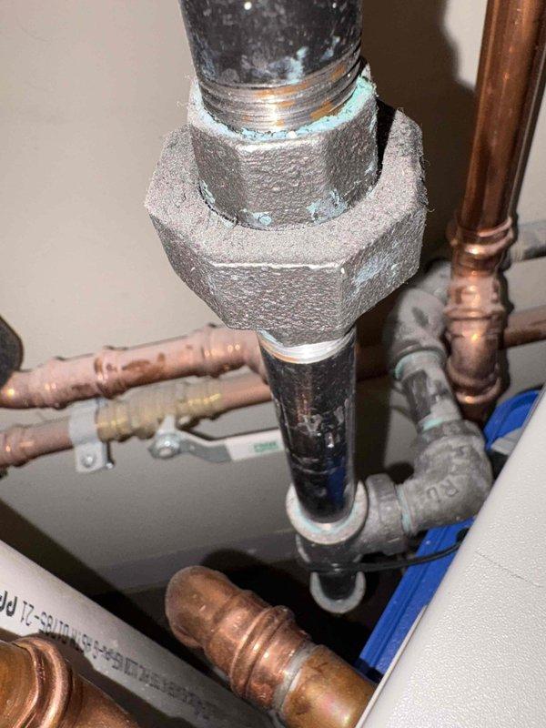 Responded to municipal inspection correction requiring installation of sediment trap on gas line downstream of shut-off valve per MRC G2419.4 code requirements. Installed compliant sediment trap at water heater gas supply line connection point, positioning trap properly after the gas shut-off valve to capture debris and protect appliance. Installation meets code specifications for sediment trap requirements where not incorporated as part of the appliance.