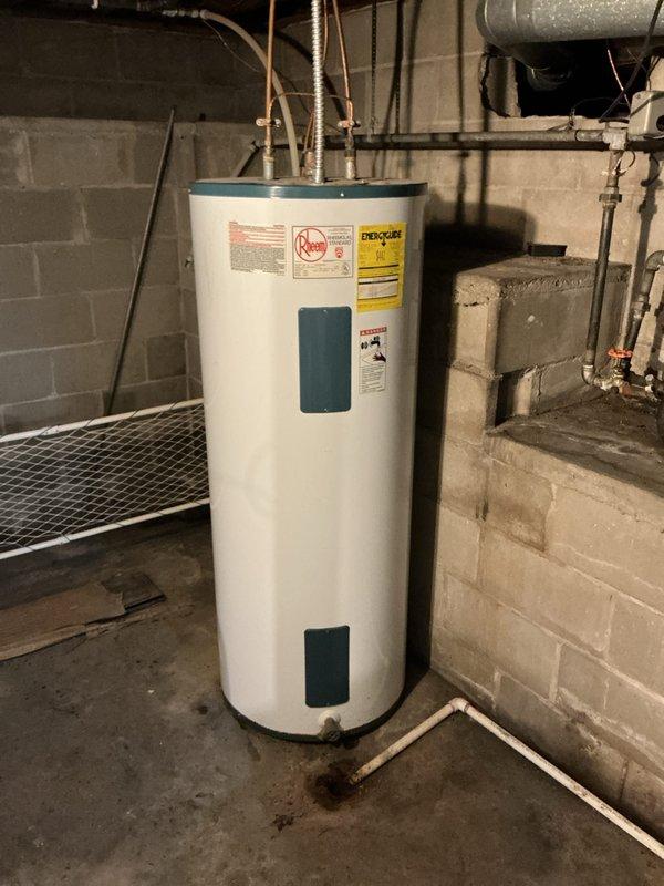 Provided estimate for water heater replacement with natural gas conversion and modification of HVAC supply registers in basement utility area. Assessed existing Rheem electric water heater and evaluated space requirements for new gas-fired unit, including necessary gas line installation, venting requirements, and code compliance considerations. Documented current HVAC system configuration with metal ductwork and beige PVC piping, and identified supply registers requiring replacement or modification to improve airflow distribution.