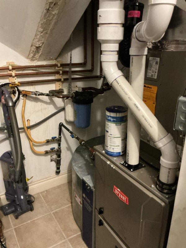 Responded to complaint of foul odor in domestic water supply. Inspected 8-year-old American water heater and associated plumbing system. Evaluated water filtration equipment including blue and white cartridge filters mounted on HVAC system and water softener installation. Tested water quality at multiple fixtures throughout home including bathroom with freestanding tub. Identified sulfur bacteria buildup in water heater as source of odor. Flushed water heater tank, inspected anode rod condition, and verified proper operation of water treatment systems. Confirmed resolution of odor issue and restored normal water quality throughout residence.