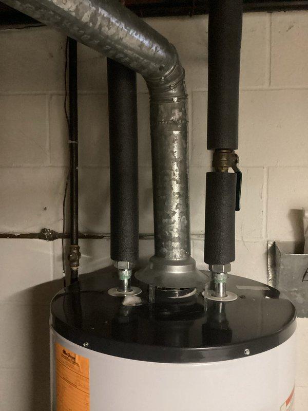 Responded to water leak investigation near boiler and water heater. Performed visual inspection of mechanical room to identify source of moisture concern. Documented existing conditions of water heater installation, associated plumbing connections, and overhead mechanical systems including HVAC ductwork and exposed piping in utility space. Customer awaiting estimate for potential equipment replacement.