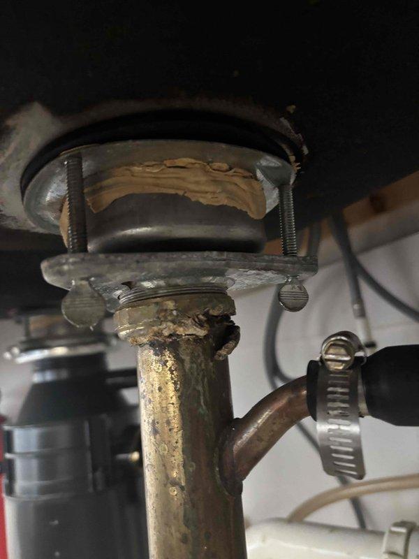 Replaced customer-supplied garbage disposal unit. Inspected plumbing system and discovered excessive water pressure (100-110 psi) as indicated by pressure gauge reading. Observed significant corrosion and mineral buildup on drain assembly. Corrected whistling noise in shower that was related to the high water pressure condition. Replaced customer-supplied garbage disposal unit. Inspected plumbing system and discovered excessive water pressure (100-110 psi) as indicated by pressure gauge reading. Observed significant corrosion and mineral buildup on drain assembly. Corrected whistling noise in shower that was related to the high water pressure condition.