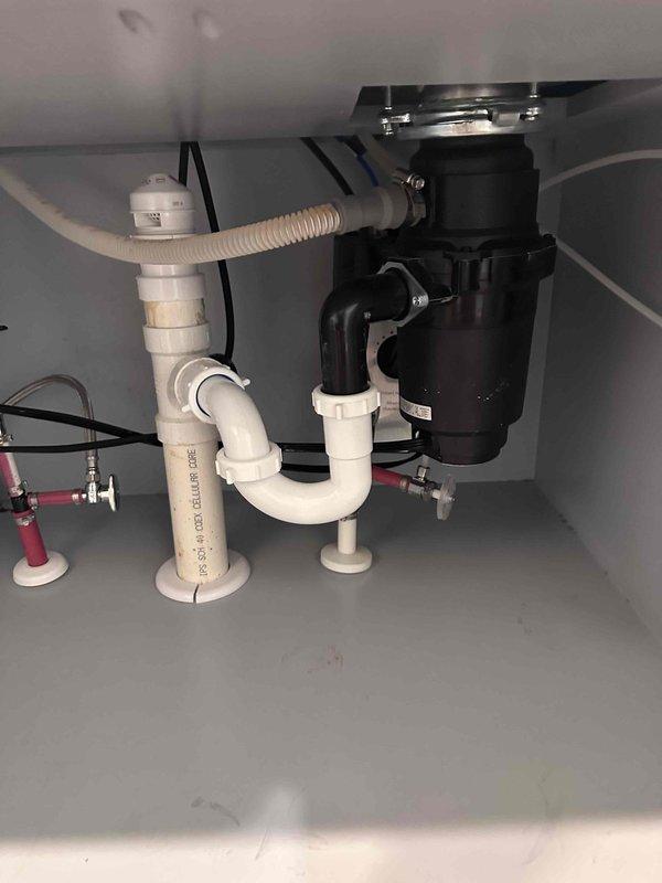 Inspected customer's electric water heater drainage system after reported concerns about water trapped in drain line. Upon examination, found functional PVC drainage setup with proper P-trap installation that is working as designed. Verified water in trap is normal and necessary to prevent sewer gas entry; system is operating correctly with no blockages or freezing issues observed. Inspected customer's electric water heater drainage system after reported concerns about water trapped in drain line. Upon examination, found functional PVC drainage setup with proper P-trap installation that is working as designed. Verified water in trap is normal and necessary to prevent sewer gas entry; system is operating correctly with no blockages or freezing issues observed.