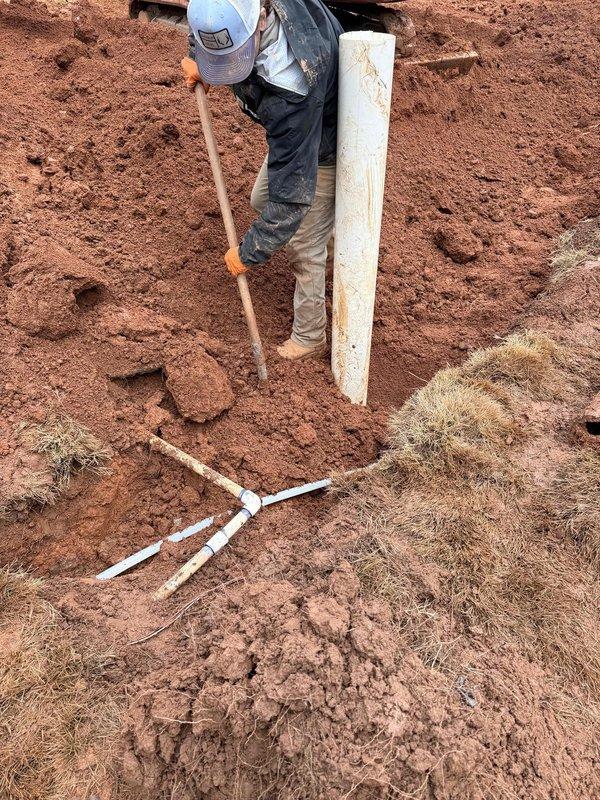 Completed sewer and water line replacement as specified in approved quote. Excavated trench and installed new white PVC piping sections along the length of the excavation. Worker properly positioned and connected plumbing components in accordance with installation requirements. Completed sewer and water line replacement as specified in approved quote. Excavated trench and installed new white PVC piping sections along the length of the excavation. Worker properly positioned and connected plumbing components in accordance with installation requirements.