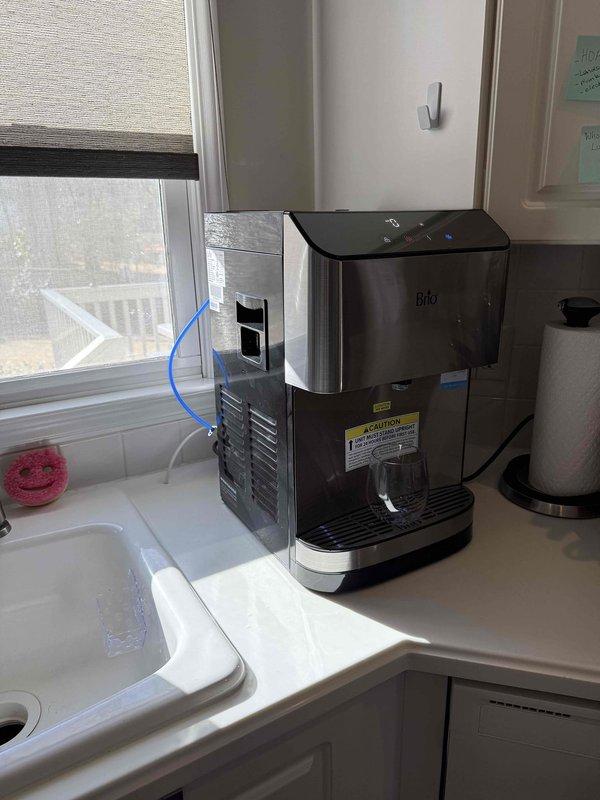 Connected kitchen sink cold water line to Brio Bottleless Countertop Water Cooler using appropriate compression fittings and T-junction valve assembly. Installed water supply line from existing plumbing to unit, verified proper operation with no leaks at connection points. Connected kitchen sink cold water line to Brio Bottleless Countertop Water Cooler using appropriate compression fittings and T-junction valve assembly. Installed water supply line from existing plumbing to unit, verified proper operation with no leaks at connection points.