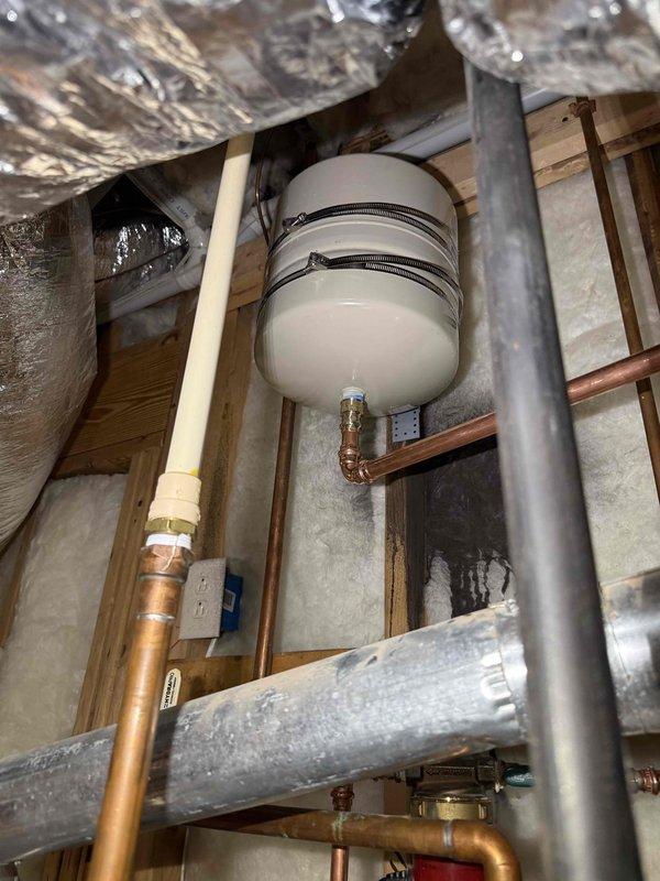 Inspected dual 50-gallon water heaters due to customer complaint of brown/rusty water appearing when hot water is first used. Examined expansion tank and copper piping system, finding minimal oxidation in the lines. Circulation pump and valve controller were operational with no visible leaks or deterioration. Recommended periodic flushing of water heaters to remove sediment buildup causing discoloration rather than full replacement at this time. Inspected dual 50-gallon water heaters due to customer complaint of brown/rusty water appearing when hot water is first used. Examined expansion tank and copper piping system, finding minimal oxidation in the lines. Circulation pump and valve controller were operational with no visible leaks or deterioration. Recommended periodic flushing of water heaters to remove sediment buildup causing discoloration rather than full replacement at this time.