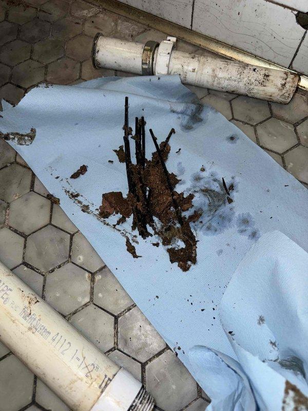 Cleared severely clogged drain pipe containing significant buildup of debris and metal fragments. Identified damaged sink connection with deteriorated material around pipe entry point, suggesting water damage or improper previous installation. Repaired leaking sink by replacing damaged fittings and ensuring proper seal at connection point. Cleared severely clogged drain pipe containing significant buildup of debris and metal fragments. Identified damaged sink connection with deteriorated material around pipe entry point, suggesting water damage or improper previous installation. Repaired leaking sink by replacing damaged fittings and ensuring proper seal at connection point.