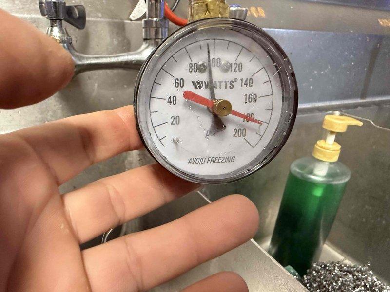 Inspected 100 gallon gas water heater reported to be leaking. Checked system pressure using WATTS gauge, which indicated approximately 50-60 PSI, within normal operating range. Identified leak source and repaired connections to resolve issue. Inspected 100 gallon gas water heater reported to be leaking. Checked system pressure using WATTS gauge, which indicated approximately 50-60 PSI, within normal operating range. Identified leak source and repaired connections to resolve issue.