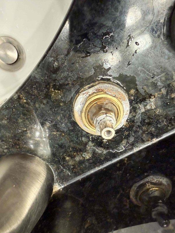 Inspected dual water heater system (50-gallon and 40-gallon gas units) for potential replacement. Documented significant aging and wear on both units. Examined bathtub faucet showing mineral deposits and corrosion on valve stem causing persistent drip. Also identified active leak under sink with visible water damage and mineral buildup around brass fitting. Recommended consolidation to single water heater unit of appropriate capacity based on household demand. Inspected dual water heater system (50-gallon and 40-gallon gas units) for potential replacement. Documented significant aging and wear on both units. Examined bathtub faucet showing mineral deposits and corrosion on valve stem causing persistent drip. Also identified active leak under sink with visible water damage and mineral buildup around brass fitting. Recommended consolidation to single water heater unit of appropriate capacity based on household demand.