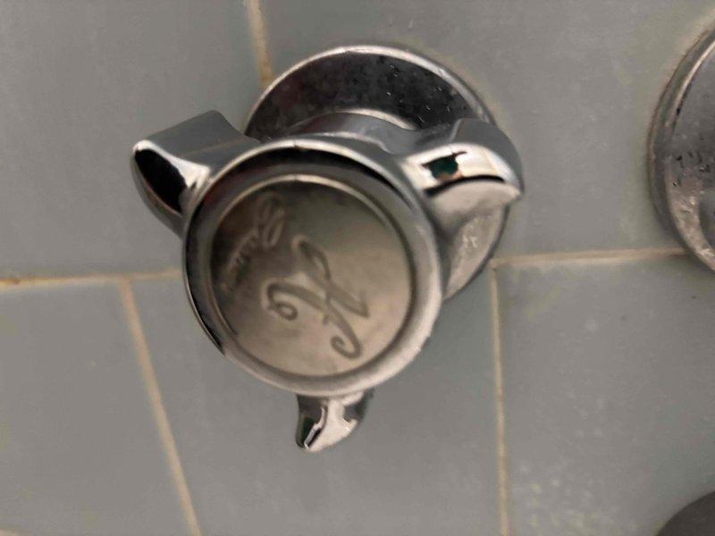 Inspected water damage on first floor ceiling directly below upstairs bathroom. Identified two circular water stains with brown rings indicating active leak. Examined bathroom and found hot water faucet leaking, causing water to penetrate floor and ceiling below. Repaired faulty faucet to eliminate the source of the leak. Inspected water damage on first floor ceiling directly below upstairs bathroom. Identified two circular water stains with brown rings indicating active leak. Examined bathroom and found hot water faucet leaking, causing water to penetrate floor and ceiling below. Repaired faulty faucet to eliminate the source of the leak.