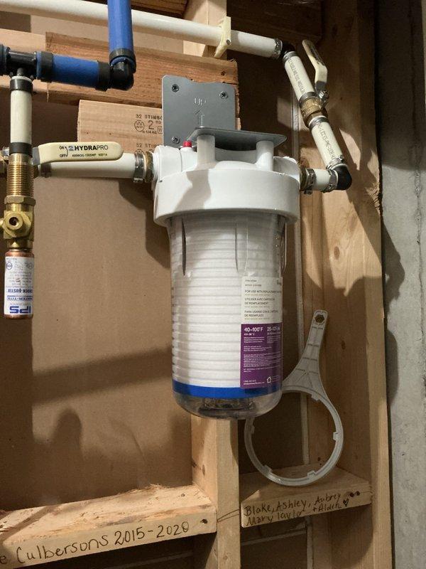 Chamblee, GA - Completed installation of water filtration system in utility area as per approved quote. Installed cylindrical water filter housing with cartridge filter, connected system using a combination of PVC pipes, PEX tubing, and brass fittings. Mounted filtration assembly securely to wooden framing and left filter wrench attached for future maintenance access. Chamblee, GA - Completed installation of water filtration system in utility area as per approved quote. Installed cylindrical water filter housing with cartridge filter, connected system using a combination of PVC pipes, PEX tubing, and brass fittings. Mounted filtration assembly securely to wooden framing and left filter wrench attached for future maintenance access.