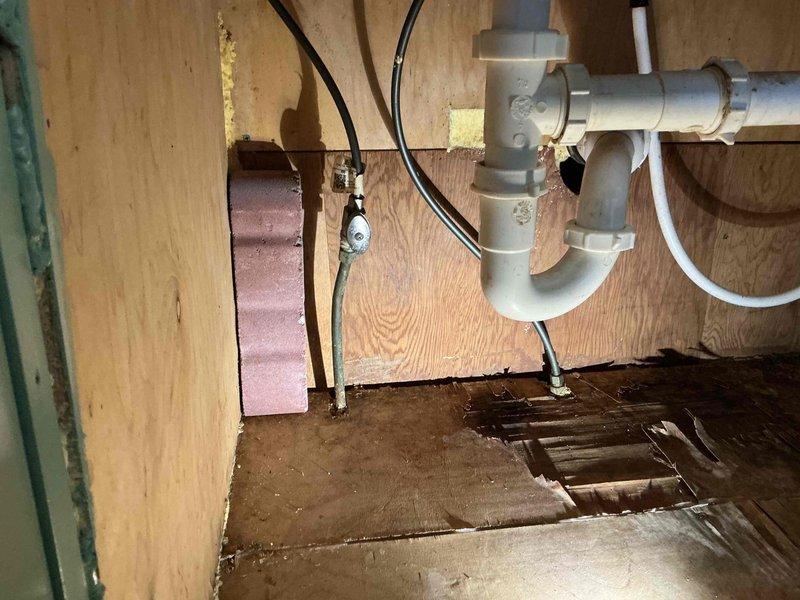 Responded to service call for kitchen sink leak and potential clog. Inspection revealed aging cast iron drainage system with significant rust and deterioration. Installed new PVC P-trap assembly and drain components to resolve leak issue. Noted water damage to cabinet flooring and subflooring from previous leakage. Responded to service call for kitchen sink leak and potential clog. Inspection revealed aging cast iron drainage system with significant rust and deterioration. Installed new PVC P-trap assembly and drain components to resolve leak issue. Noted water damage to cabinet flooring and subflooring from previous leakage.