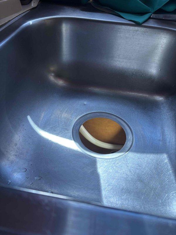 Responded to service call for leaking sink with drainage issues. Inspected double-basin kitchen sink where garbage disposal side was leaking and second basin wasn't draining properly. Customer also reported water in unfinished basement, but source couldn't be definitively determined as it may be weather-related with no visible ceiling damage in the affected area. Responded to service call for leaking sink with drainage issues. Inspected double-basin kitchen sink where garbage disposal side was leaking and second basin wasn't draining properly. Customer also reported water in unfinished basement, but source couldn't be definitively determined as it may be weather-related with no visible ceiling damage in the affected area.