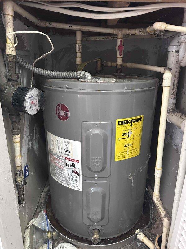Responded to leak complaint on standard Rheem water heater. Diagnosed corrosion at inlet pipe connection on top of unit. Replaced deteriorated brass/copper fitting and sealed connection with appropriate plumbing tape. System tested with no leaks observed. Responded to leak complaint on standard Rheem water heater. Diagnosed corrosion at inlet pipe connection on top of unit. Replaced deteriorated brass/copper fitting and sealed connection with appropriate plumbing tape. System tested with no leaks observed.
