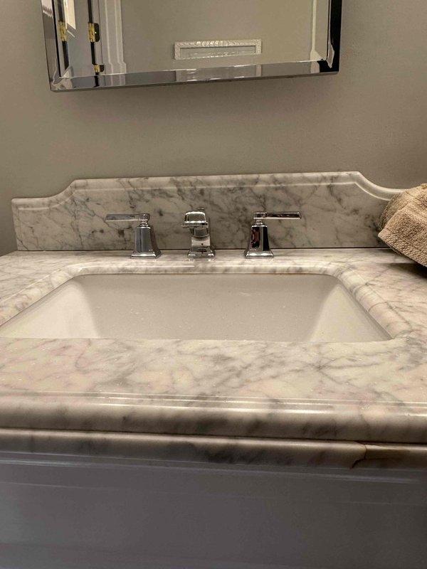 Repaired leaking bathroom faucet in marble vanity sink. Removed and replaced worn supply line fittings after placing protective cloths under sink area. Tested operation after repair to confirm proper function with no leaks. Repaired leaking bathroom faucet in marble vanity sink. Removed and replaced worn supply line fittings after placing protective cloths under sink area. Tested operation after repair to confirm proper function with no leaks.