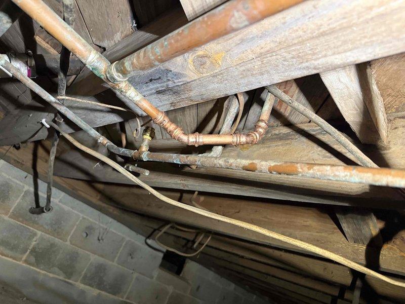 Responded to service call for bathroom plumbing issues where shower usage caused toilet to gurgle. Inspection of basement plumbing revealed significant corrosion on copper pipes with visible green oxidation at multiple connection points. Cleared main line clog that was causing cross-fixture backup, restoring proper drainage to both bathroom fixtures. Responded to service call for bathroom plumbing issues where shower usage caused toilet to gurgle. Inspection of basement plumbing revealed significant corrosion on copper pipes with visible green oxidation at multiple connection points. Cleared main line clog that was causing cross-fixture backup, restoring proper drainage to both bathroom fixtures.