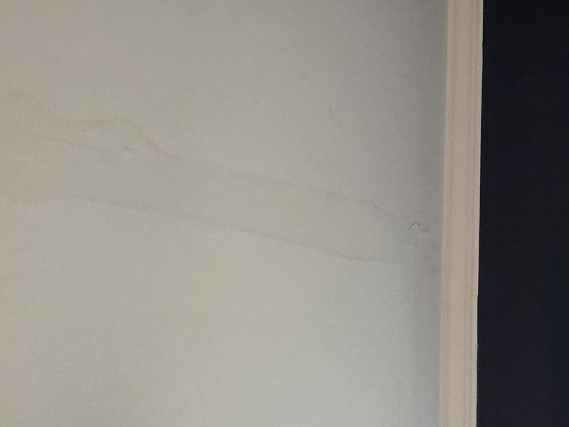 Located and identified water damage on interior wall and ceiling, evidenced by discoloration and staining on white wall surface and a visible crack along the ceiling corner. Completed repair of leaking plumbing fixture that was causing water to seep into the wall, preventing further structural damage to the affected areas. Located and identified water damage on interior wall and ceiling, evidenced by discoloration and staining on white wall surface and a visible crack along the ceiling corner. Completed repair of leaking plumbing fixture that was causing water to seep into the wall, preventing further structural damage to the affected areas.