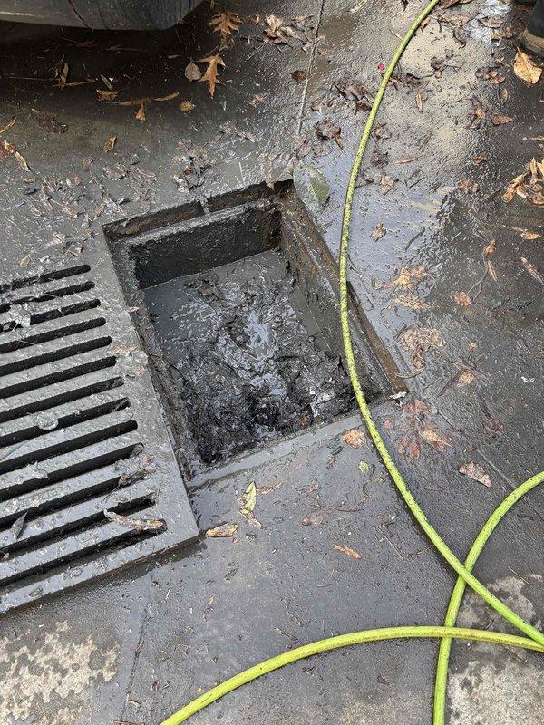 Performed approved jetting service on severely corroded metal catch basin system showing multiple compartments with standing water and sediment buildup. Cleared rectangular drain opening and surrounding concrete drainage area where water was pooling. Customer was provided with recommendation for permanent repair due to extensive rust damage and deterioration observed throughout the drainage structure. Performed approved jetting service on severely corroded metal catch basin system showing multiple compartments with standing water and sediment buildup. Cleared rectangular drain opening and surrounding concrete drainage area where water was pooling. Customer was provided with recommendation for permanent repair due to extensive rust damage and deterioration observed throughout the drainage structure.