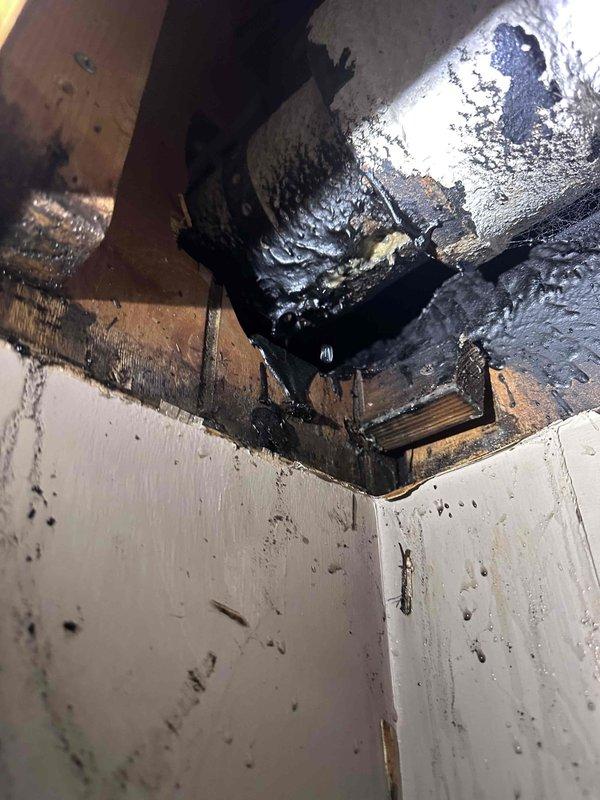 Investigated leak in basement ceiling, identified cast iron drainage pipe (KMDS-44) with significant leakage causing water damage to surrounding wooden structure. Observed substantial dark liquid seeping through ceiling and running down walls, with evidence of prolonged moisture exposure affecting both the wooden framing and drywall surfaces. Investigated leak in basement ceiling, identified cast iron drainage pipe (KMDS-44) with significant leakage causing water damage to surrounding wooden structure. Observed substantial dark liquid seeping through ceiling and running down walls, with evidence of prolonged moisture exposure affecting both the wooden framing and drywall surfaces.