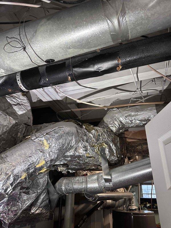 Conducted comprehensive inspection of HVAC ductwork system, documenting both interior and exterior components. Interior inspection revealed multiple metal ducts of varying sizes with visible insulated piping and flexible foil-wrapped connections. Exterior assessment identified two dome roof vents and examined gutter system condition, noting some weathering and fascia deterioration. Conducted comprehensive inspection of HVAC ductwork system, documenting both interior and exterior components. Interior inspection revealed multiple metal ducts of varying sizes with visible insulated piping and flexible foil-wrapped connections. Exterior assessment identified two dome roof vents and examined gutter system condition, noting some weathering and fascia deterioration.