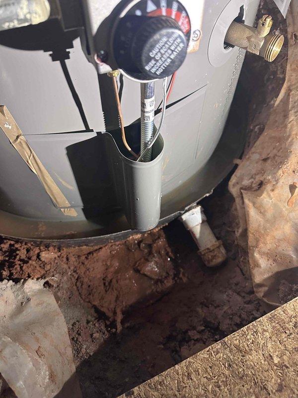 Inspected water heater installed approximately one year ago that had water accumulating in the drain pan. Verified proper burner operation through sight glass and examined installation area. Found no active leaks at water connections or TPR valve, suggesting condensation or previous minor leak that has since stopped. Inspected water heater installed approximately one year ago that had water accumulating in the drain pan. Verified proper burner operation through sight glass and examined installation area. Found no active leaks at water connections or TPR valve, suggesting condensation or previous minor leak that has since stopped.