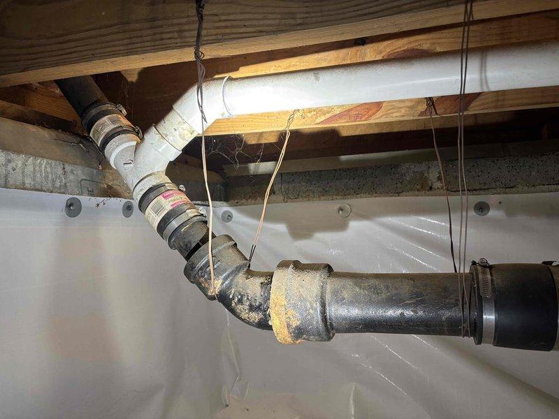 Responded to service call for slow kitchen sink drainage and sump pump issues. Inspection revealed mineral deposits and corrosion on basement drainage pipes, particularly at PVC elbow joints. Successfully cleared blockage and restored proper drainage function throughout the system. Responded to service call for slow kitchen sink drainage and sump pump issues. Inspection revealed mineral deposits and corrosion on basement drainage pipes, particularly at PVC elbow joints. Successfully cleared blockage and restored proper drainage function throughout the system.