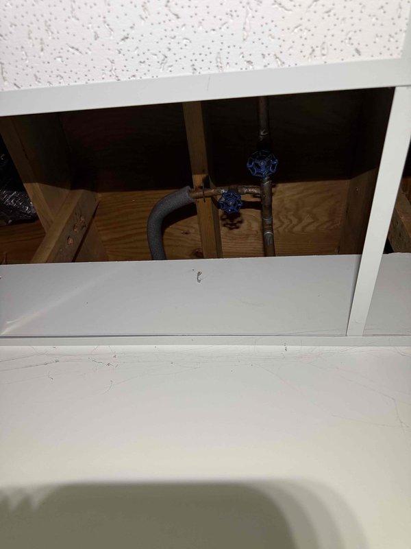 Responded to service call for shower leak. Upon inspection, accessed ceiling panel to examine plumbing components, revealing shut-off valves with blue handles and insulated pipes connected to the water supply system. Tightened loose valve connection that was causing the leak and verified proper water flow and drainage after repair. Responded to service call for shower leak. Upon inspection, accessed ceiling panel to examine plumbing components, revealing shut-off valves with blue handles and insulated pipes connected to the water supply system. Tightened loose valve connection that was causing the leak and verified proper water flow and drainage after repair.