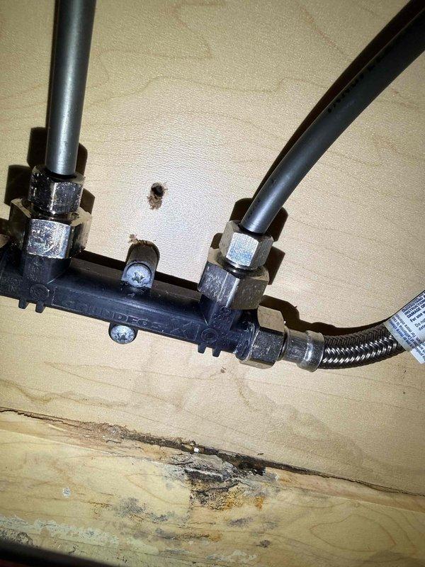 Responded to service call for leak under master sink. Inspection revealed significant water damage to the cabinet base with deterioration and discoloration visible around the plumbing fixtures. Identified leak source at the compression fittings connecting the braided supply lines to the shutoff valves, replaced damaged fittings and verified proper operation with no further leakage. Responded to service call for leak under master sink. Inspection revealed significant water damage to the cabinet base with deterioration and discoloration visible around the plumbing fixtures. Identified leak source at the compression fittings connecting the braided supply lines to the shutoff valves, replaced damaged fittings and verified proper operation with no further leakage.