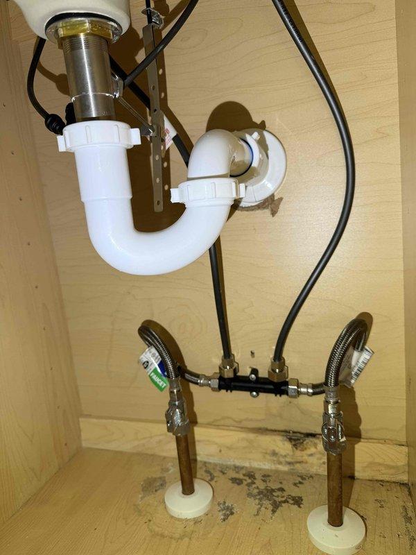 Responded to service call for leak under master sink. Inspection revealed significant water damage to the cabinet base with deterioration and discoloration visible around the plumbing fixtures. Identified leak source at the compression fittings connecting the braided supply lines to the shutoff valves, replaced damaged fittings and verified proper operation with no further leakage. Responded to service call for leak under master sink. Inspection revealed significant water damage to the cabinet base with deterioration and discoloration visible around the plumbing fixtures. Identified leak source at the compression fittings connecting the braided supply lines to the shutoff valves, replaced damaged fittings and verified proper operation with no further leakage.