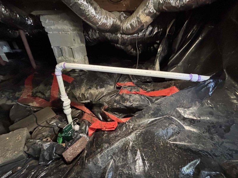 Replaced faulty sump pump and installed new PVC drain pipe in crawlspace. Properly secured connections with purple primer/cement at joints. Vapor barrier was adjusted as needed to accommodate the new plumbing components. Replaced faulty sump pump and installed new PVC drain pipe in crawlspace. Properly secured connections with purple primer/cement at joints. Vapor barrier was adjusted as needed to accommodate the new plumbing components.