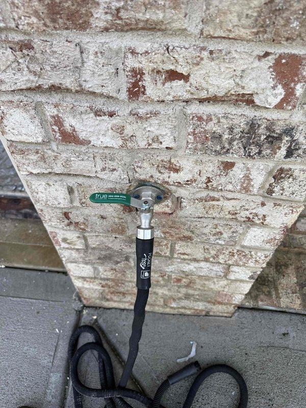 Rerouted hose spigot piping through existing wall structure, replacing damaged connections with new Hi-Flo fittings. Accessed ceiling joists to properly route supply line, ensuring proper insulation clearance around the new plumbing pathway.
