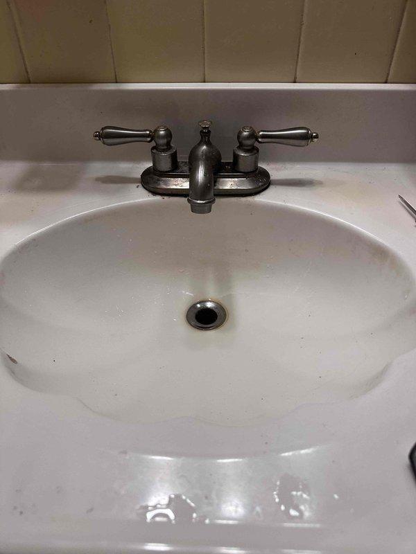 Responded to service call for kitchen faucet leak. Upon inspection, identified a deteriorated valve washer in the aged bathroom sink faucet with brushed nickel/bronze finish. Replaced worn washer and tested fixture functionality, confirming successful repair with no further leakage. Responded to service call for kitchen faucet leak. Upon inspection, identified a deteriorated valve washer in the aged bathroom sink faucet with brushed nickel/bronze finish. Replaced worn washer and tested fixture functionality, confirming successful repair with no further leakage.