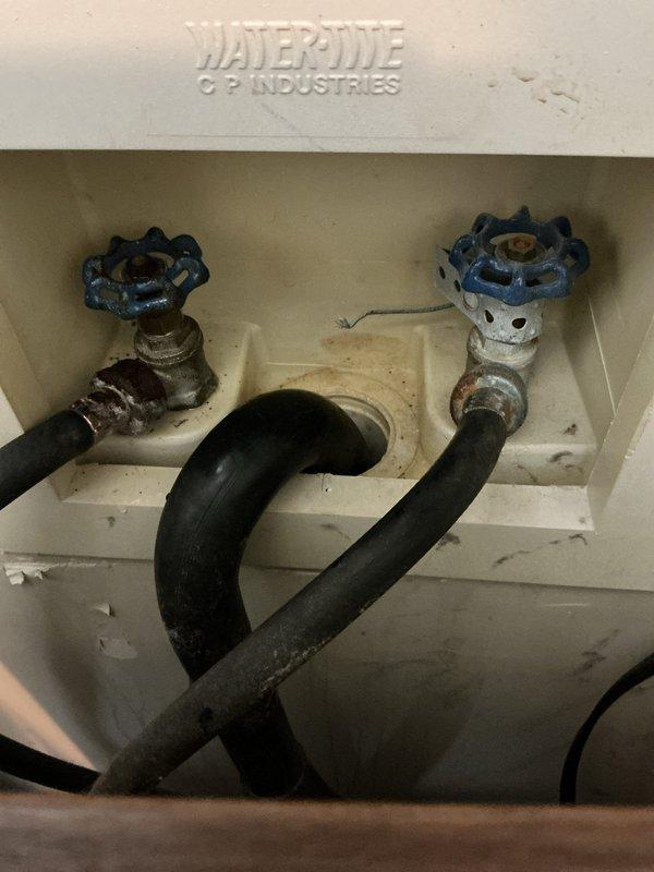Responded to service call for leaky hot water spigot in WaterOne/WaterPure washing machine connection box. Inspected and replaced corroded hot water valve that was showing significant mineral buildup and staining in the housing. Customer also reported reduced hot water duration; recommended water heater flush service as preventative maintenance to address this separate issue.