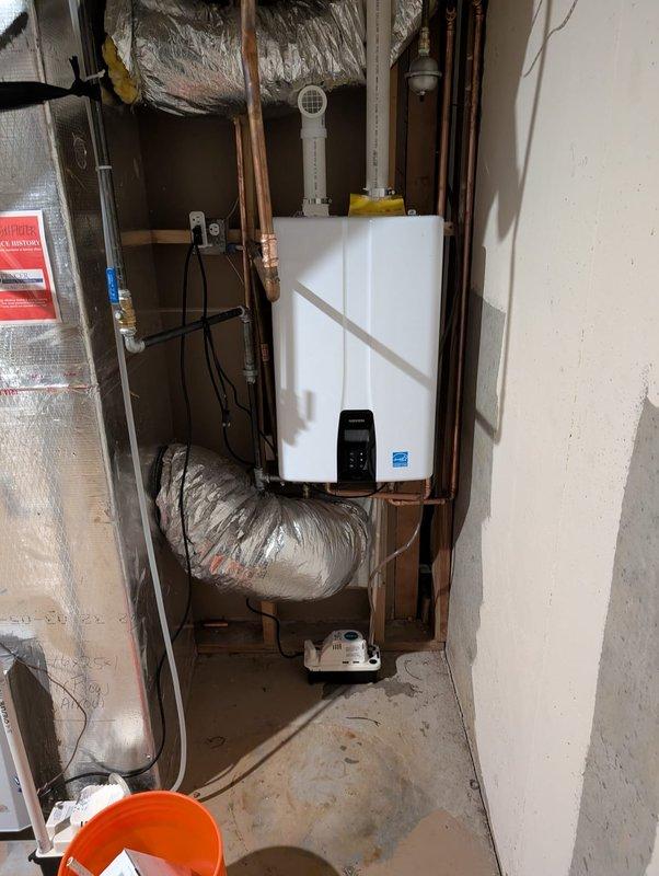 Completed installation of a wall-mounted tankless water heater in residential utility space. Connected unit to existing copper plumbing lines and installed PVC venting system. Verified proper functionality of digital control panel and ensured all connections were secure with no leaks present. Completed installation of a wall-mounted tankless water heater in residential utility space. Connected unit to existing copper plumbing lines and installed PVC venting system. Verified proper functionality of digital control panel and ensured all connections were secure with no leaks present.