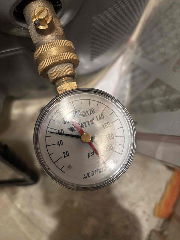 Responded to service call for kitchen sink leak suspected to be from garbage disposal. Inspection revealed significant corrosion and rust buildup at the disposal's mounting assembly and flange area. Water pressure was measured at approximately 75-80 PSI using a Watts gauge. Responded to service call for kitchen sink leak suspected to be from garbage disposal. Inspection revealed significant corrosion and rust buildup at the disposal's mounting assembly and flange area. Water pressure was measured at approximately 75-80 PSI using a Watts gauge.