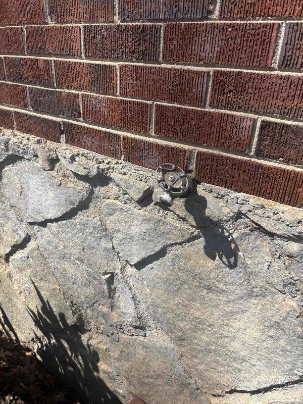 Replaced two leaking exterior hose spigots and addressed code compliance concerns with the main water shutoff valve. Inspection revealed weathered foundation with visible cracking near valve mounting points and structural junction issues where wooden framing meets the foundation wall. Installation of new fixtures completed with proper sealing to prevent future water infiltration. Replaced two leaking exterior hose spigots and addressed code compliance concerns with the main water shutoff valve. Inspection revealed weathered foundation with visible cracking near valve mounting points and structural junction issues where wooden framing meets the foundation wall. Installation of new fixtures completed with proper sealing to prevent future water infiltration.