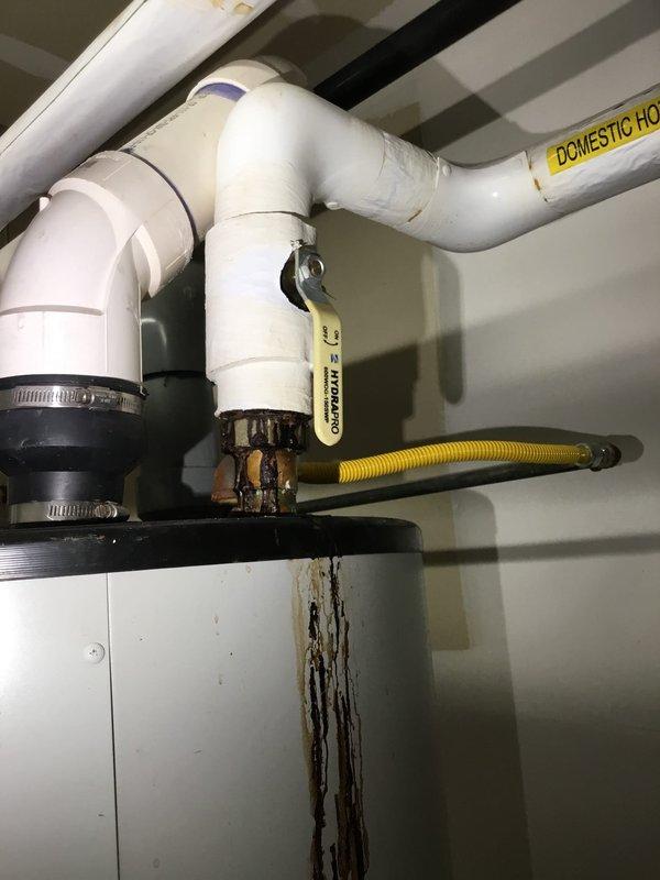 Performed inspection of domestic hot water system with significant corrosion and pipe failure at connection point between PVC and metal piping. Documented severe deterioration, visible hole in insulated section, and evidence of active leaking with rust and mineral deposits. Recommend immediate replacement of damaged section to prevent further water damage and potential system failure. Performed inspection of domestic hot water system with significant corrosion and pipe failure at connection point between PVC and metal piping. Documented severe deterioration, visible hole in insulated section, and evidence of active leaking with rust and mineral deposits. Recommend immediate replacement of damaged section to prevent further water damage and potential system failure.