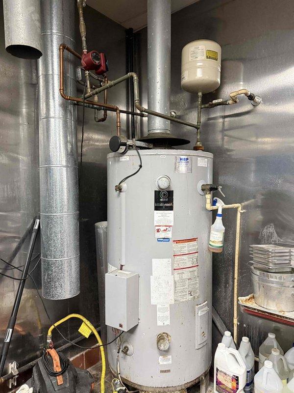 Replaced commercial 100-gallon gas water heater that had failed. Installation included connecting copper supply lines, installing new expansion tank, and properly venting the unit with galvanized flue pipe. System now operational with circulation pump functioning properly. Replaced commercial 100-gallon gas water heater that had failed. Installation included connecting copper supply lines, installing new expansion tank, and properly venting the unit with galvanized flue pipe. System now operational with circulation pump functioning properly.