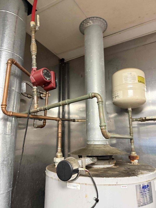 Replaced commercial 100-gallon gas water heater that had failed. Installation included connecting copper supply lines, installing new expansion tank, and properly venting the unit with galvanized flue pipe. System now operational with circulation pump functioning properly. Replaced commercial 100-gallon gas water heater that had failed. Installation included connecting copper supply lines, installing new expansion tank, and properly venting the unit with galvanized flue pipe. System now operational with circulation pump functioning properly.