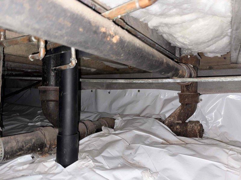 Completed sewer scope inspection and examined gas lines in the crawl space. Observed significant oxidation on metal pipes with proper vapor barrier installation in place. Noted spray foam insulation between joists and multiple plumbing systems showing age but remaining structurally intact. Completed sewer scope inspection and examined gas lines in the crawl space. Observed significant oxidation on metal pipes with proper vapor barrier installation in place. Noted spray foam insulation between joists and multiple plumbing systems showing age but remaining structurally intact.
