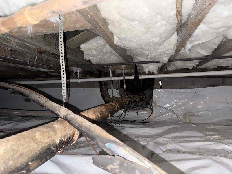 Completed sewer scope inspection and examined gas lines in the crawl space. Observed significant oxidation on metal pipes with proper vapor barrier installation in place. Noted spray foam insulation between joists and multiple plumbing systems showing age but remaining structurally intact. Completed sewer scope inspection and examined gas lines in the crawl space. Observed significant oxidation on metal pipes with proper vapor barrier installation in place. Noted spray foam insulation between joists and multiple plumbing systems showing age but remaining structurally intact.