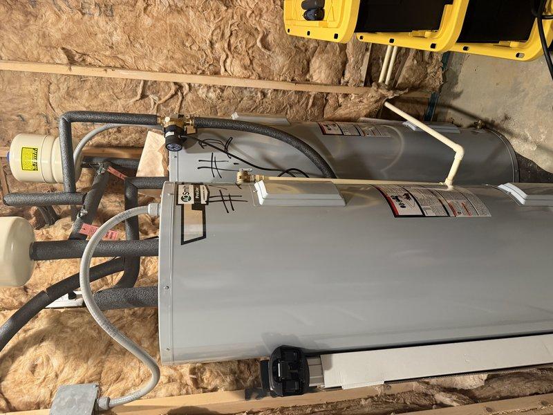 Diagnosed parallel electric water heater system experiencing lukewarm water output and occasional breaker trips on one unit. Inspected A.O. Smith dual tank installation with expansion tanks and observed possible cross-connection issue between units. Documented system configuration with photographs for further evaluation by management regarding appropriate resolution options. Diagnosed parallel electric water heater system experiencing lukewarm water output and occasional breaker trips on one unit. Inspected A.O. Smith dual tank installation with expansion tanks and observed possible cross-connection issue between units. Documented system configuration with photographs for further evaluation by management regarding appropriate resolution options.