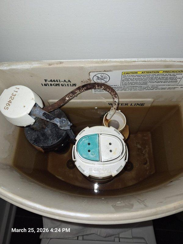 Responded to service call for direct vent water heater reported as leaking. Upon inspection, discovered the leak was originating from a toilet tank fill valve rather than the water heater system. Identified significant mineral deposits and staining around the fill valve base and connection points, indicating a chronic leak condition. The Geberit flush system components showed signs of water seepage, and the tank water level appeared discolored. Inspected the exterior direct vent termination on building exterior, which showed no signs of moisture intrusion or improper venting. Vegetation growth around the vent was noted but did not obstruct airflow. Documented conditions with photographs for customer records and provided recommendations for toilet fill valve replacement to resolve the actual source of the reported leak. Responded to service call for direct vent water heater reported as leaking. Upon inspection, discovered the leak was originating from a toilet tank fill valve rather than the water heater system. Identified significant mineral deposits and staining around the fill valve base and connection points, indicating a chronic leak condition. The Geberit flush system components showed signs of water seepage, and the tank water level appeared discolored. Inspected the exterior direct vent termination on building exterior, which showed no signs of moisture intrusion or improper venting. Vegetation growth around the vent was noted but did not obstruct airflow. Documented conditions with photographs for customer records and provided recommendations for toilet fill valve replacement to resolve the actual source of the reported leak.