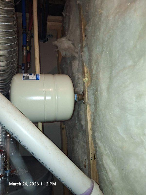 Completed water heater installation with associated pressure and expansion tank components. Installed new pressure gauge reading 0-160 PSI with brass compression fitting, mounted expansion tank with proper insulation clearance in utility area, and configured PVC drainage piping through basement framing. Verified all connections for proper operation and system pressurization. Completed water heater installation with associated pressure and expansion tank components. Installed new pressure gauge reading 0-160 PSI with brass compression fitting, mounted expansion tank with proper insulation clearance in utility area, and configured PVC drainage piping through basement framing. Verified all connections for proper operation and system pressurization.