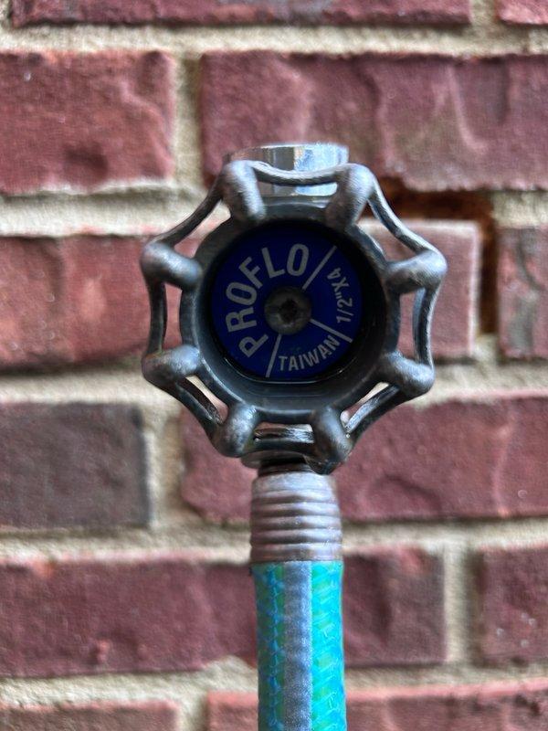 Responded to service call for leaking outdoor hose spigot on exterior brick wall. Upon inspection, identified water leakage at the connection point of the PROFLO M-21L hose bib where the fixture penetrates the wall, with visible corrosion and rust present on the galvanized metal components and copper piping. Repaired the faulty spigot assembly to restore proper function and eliminate the active leak. Responded to service call for leaking outdoor hose spigot on exterior brick wall. Upon inspection, identified water leakage at the connection point of the PROFLO M-21L hose bib where the fixture penetrates the wall, with visible corrosion and rust present on the galvanized metal components and copper piping. Repaired the faulty spigot assembly to restore proper function and eliminate the active leak.