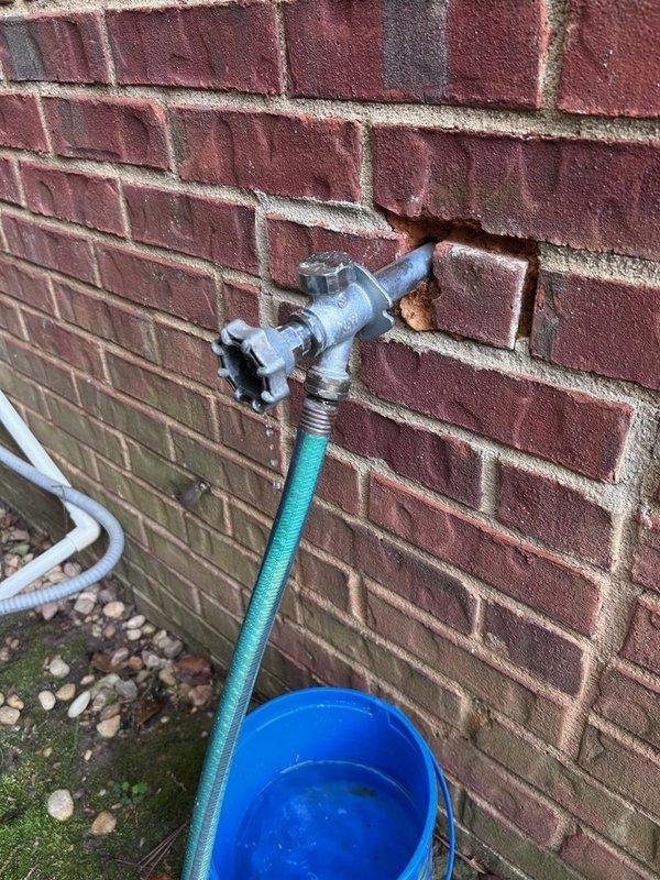 Responded to service call for leaking outdoor hose spigot on exterior brick wall. Upon inspection, identified water leakage at the connection point of the PROFLO M-21L hose bib where the fixture penetrates the wall, with visible corrosion and rust present on the galvanized metal components and copper piping. Repaired the faulty spigot assembly to restore proper function and eliminate the active leak. Responded to service call for leaking outdoor hose spigot on exterior brick wall. Upon inspection, identified water leakage at the connection point of the PROFLO M-21L hose bib where the fixture penetrates the wall, with visible corrosion and rust present on the galvanized metal components and copper piping. Repaired the faulty spigot assembly to restore proper function and eliminate the active leak.
